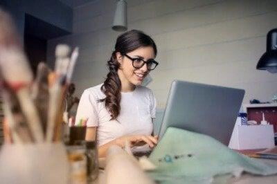 Hard working girl looking at her laptop in her office | Host Family Stay